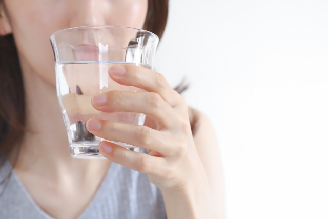 経口補水液を飲む女性
